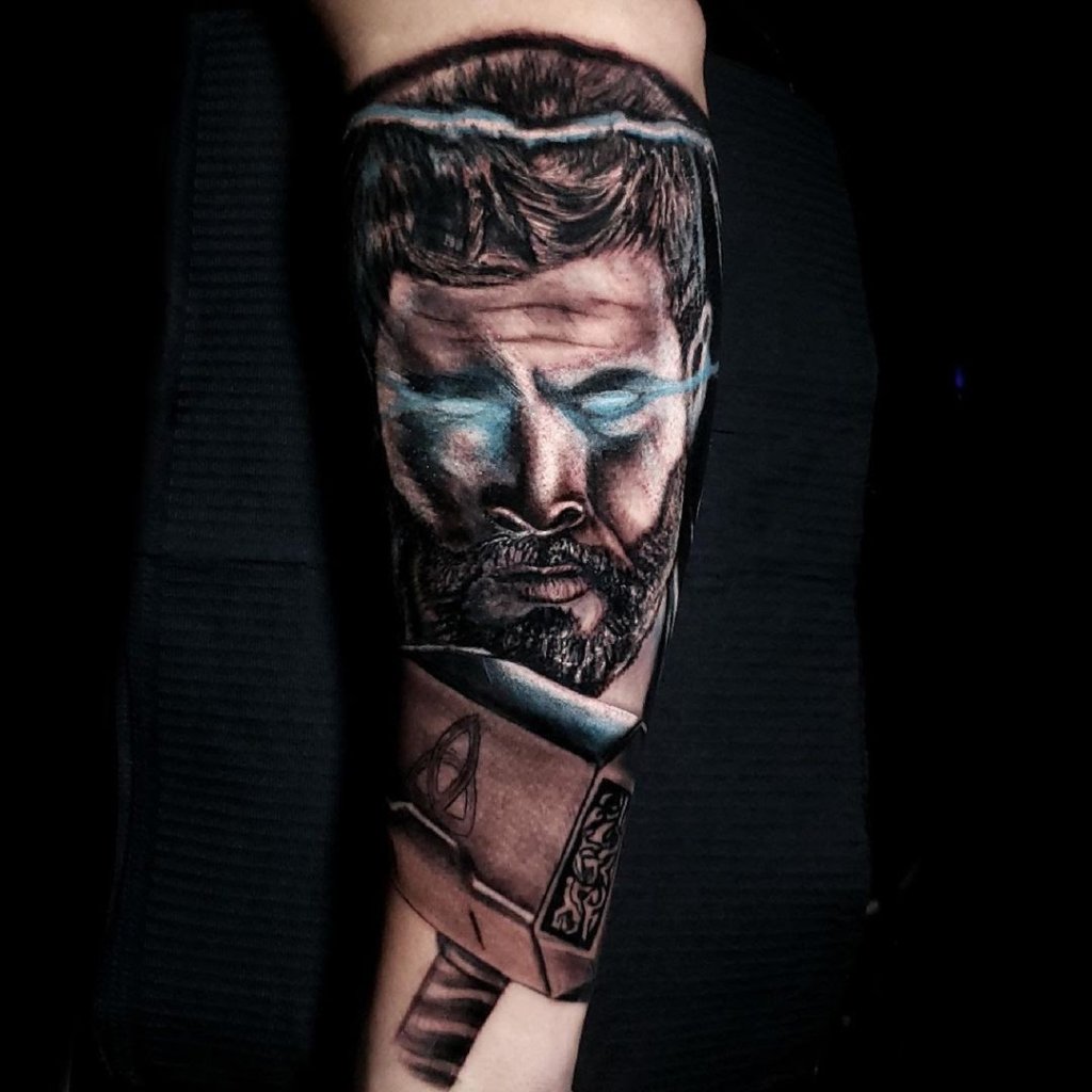 Thor Tattoo With A Pop Of Blue Ink On Arm