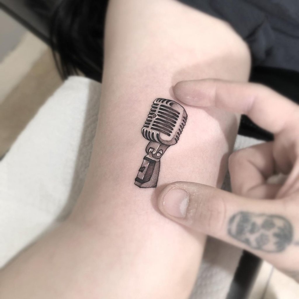 Delicate And Minimalistic Microphone Tattoo Black Design