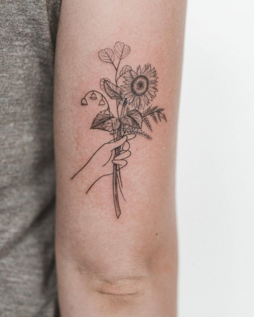Hand Holding Flower Bouquet Tattoo