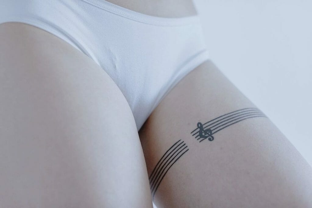Minimal Garter Tattoo Designs For Music Lovers