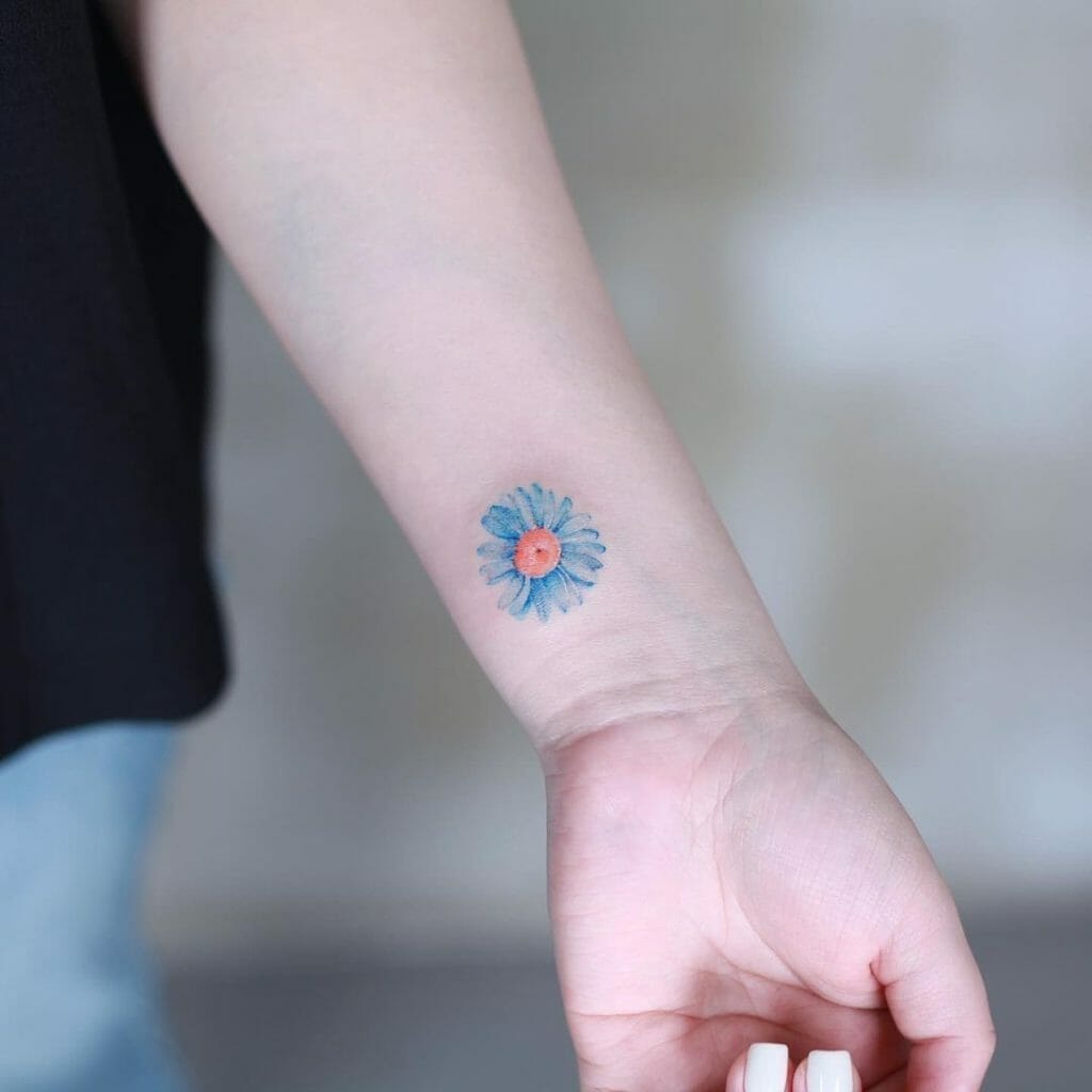 The Blue Daisy Tattoo Of Loyalty On Wrist