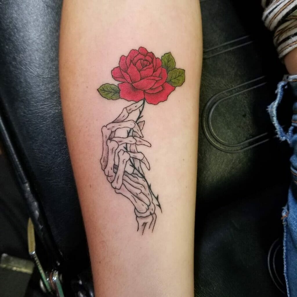Skeleton Hand Tattoo With A Rose