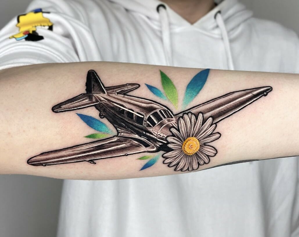 Micro airplane tattoo in minimalistic style, placed on