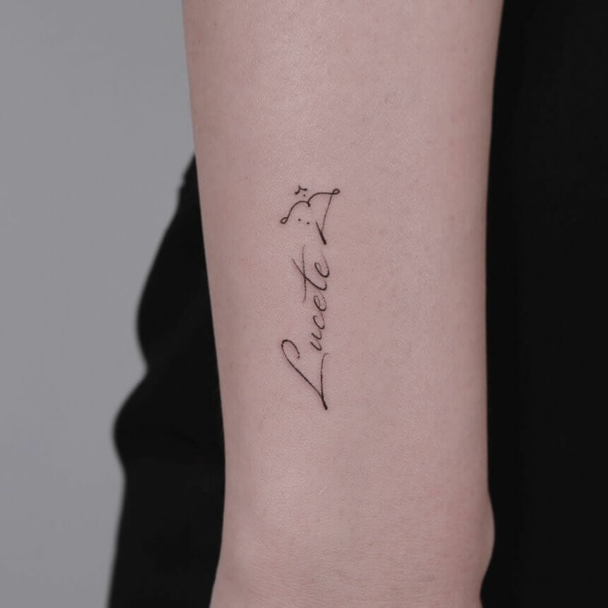 Bow And Sagittarius Arrow Tattoo Along With A Name