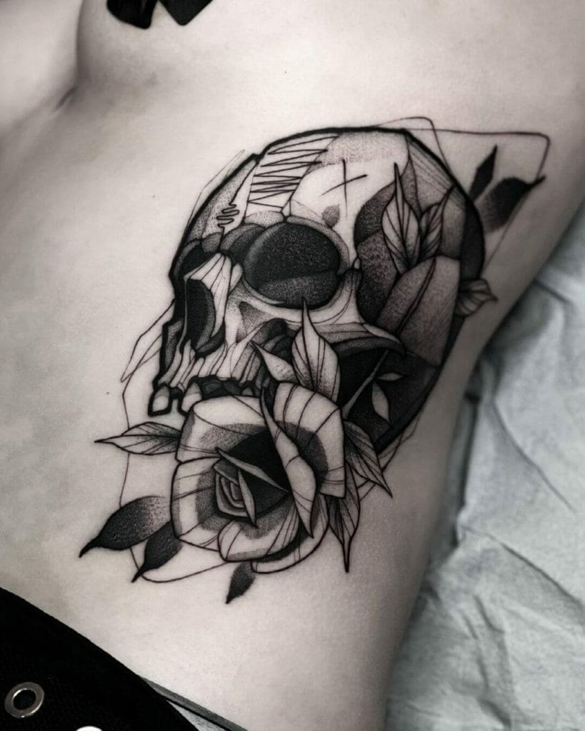 Skull Holding A Rose In The Jaw Tattoo Design