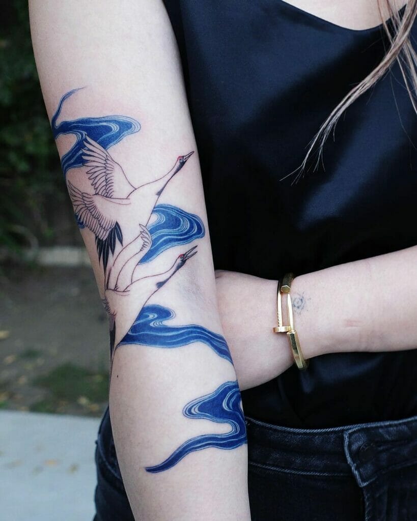 The Soothing Crane And River Tattoo On Arms