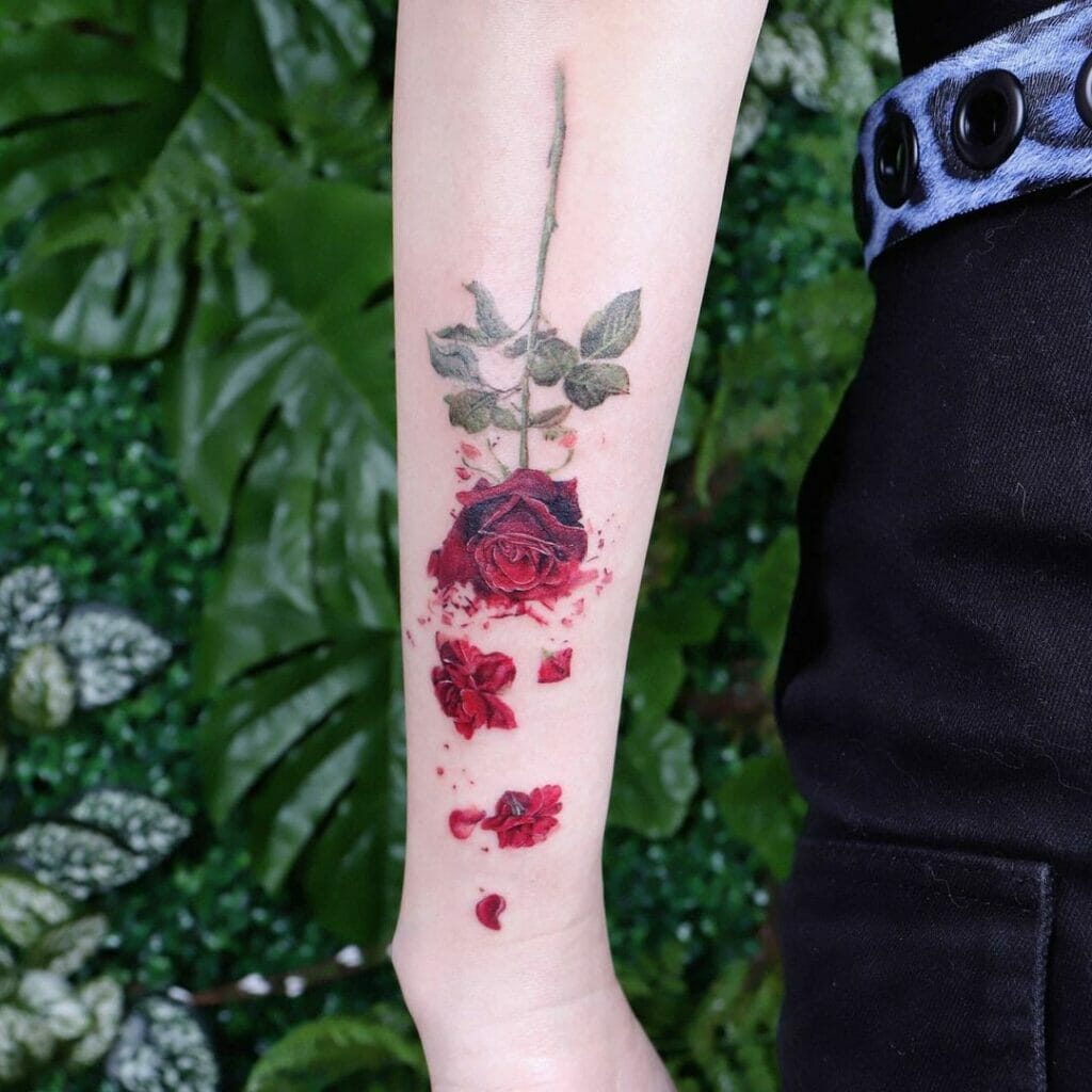 Upside Down Realistic Red Rose Tattoo With A Dark Stem