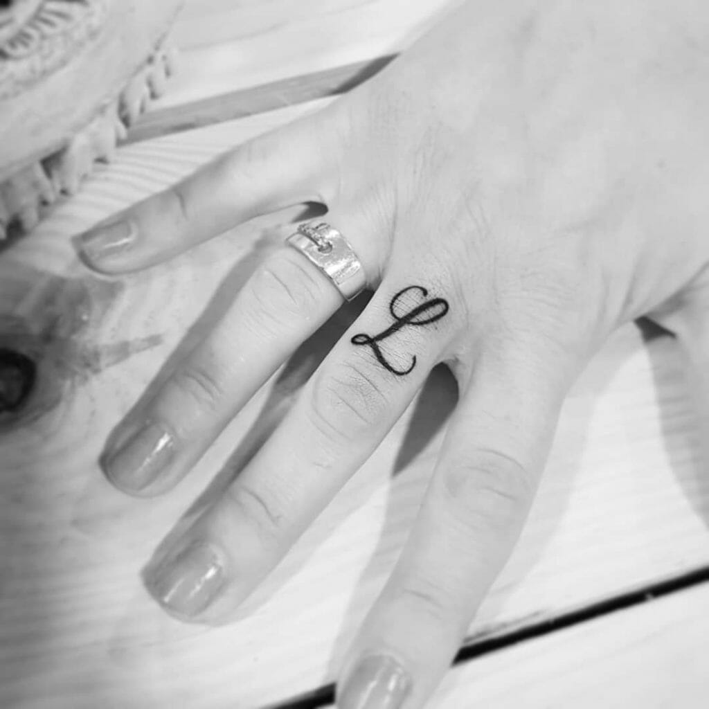 Cursive Lettering Initial Tattoo on Finger