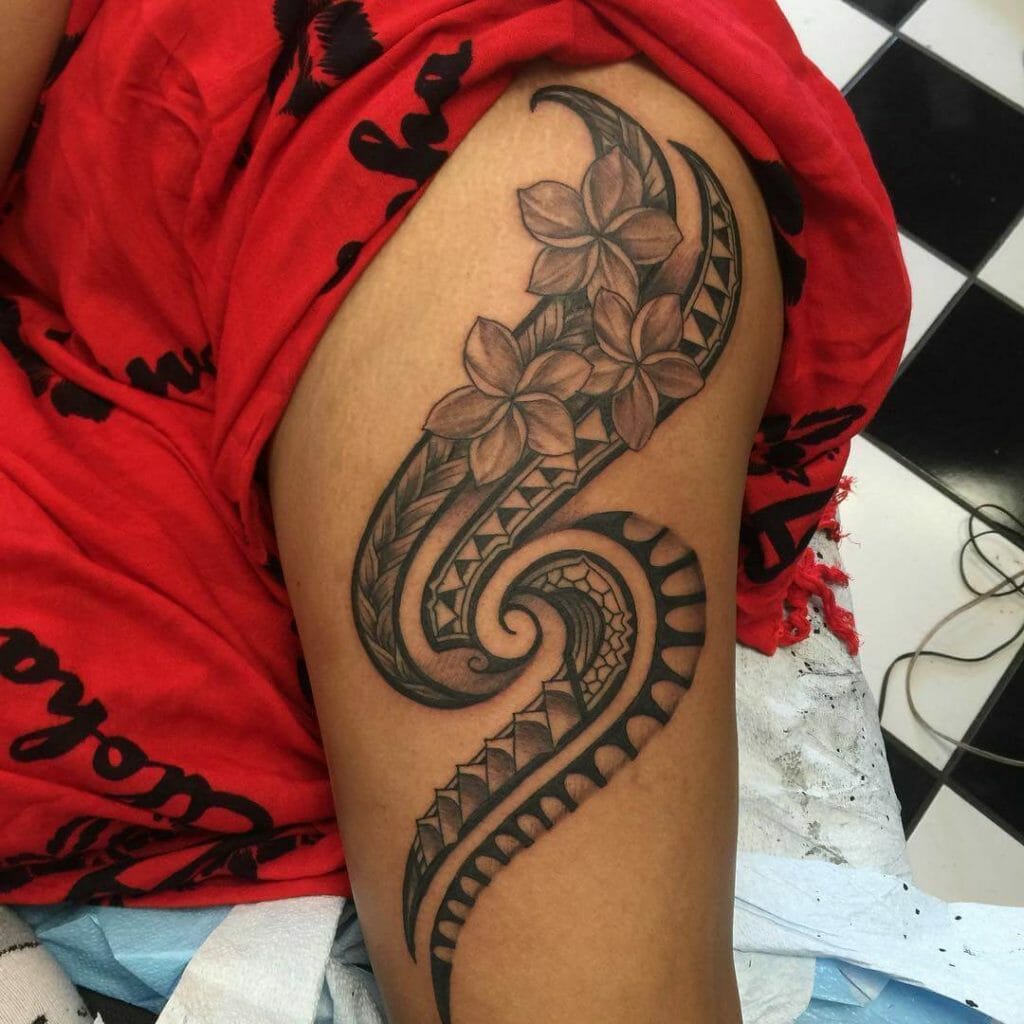 Delicate Guamanian Hook Tattoo With Floral Designs