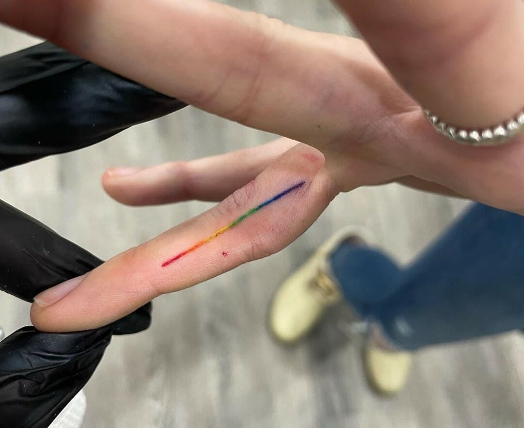 Minimalist rainbow tattoo on the wrist