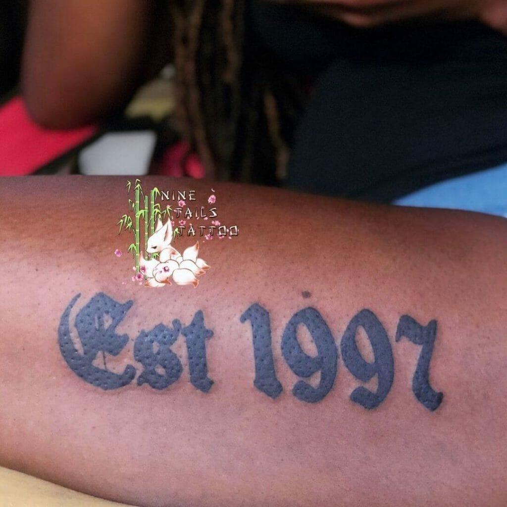 Solid 1997 Est Tattoo On Forearm