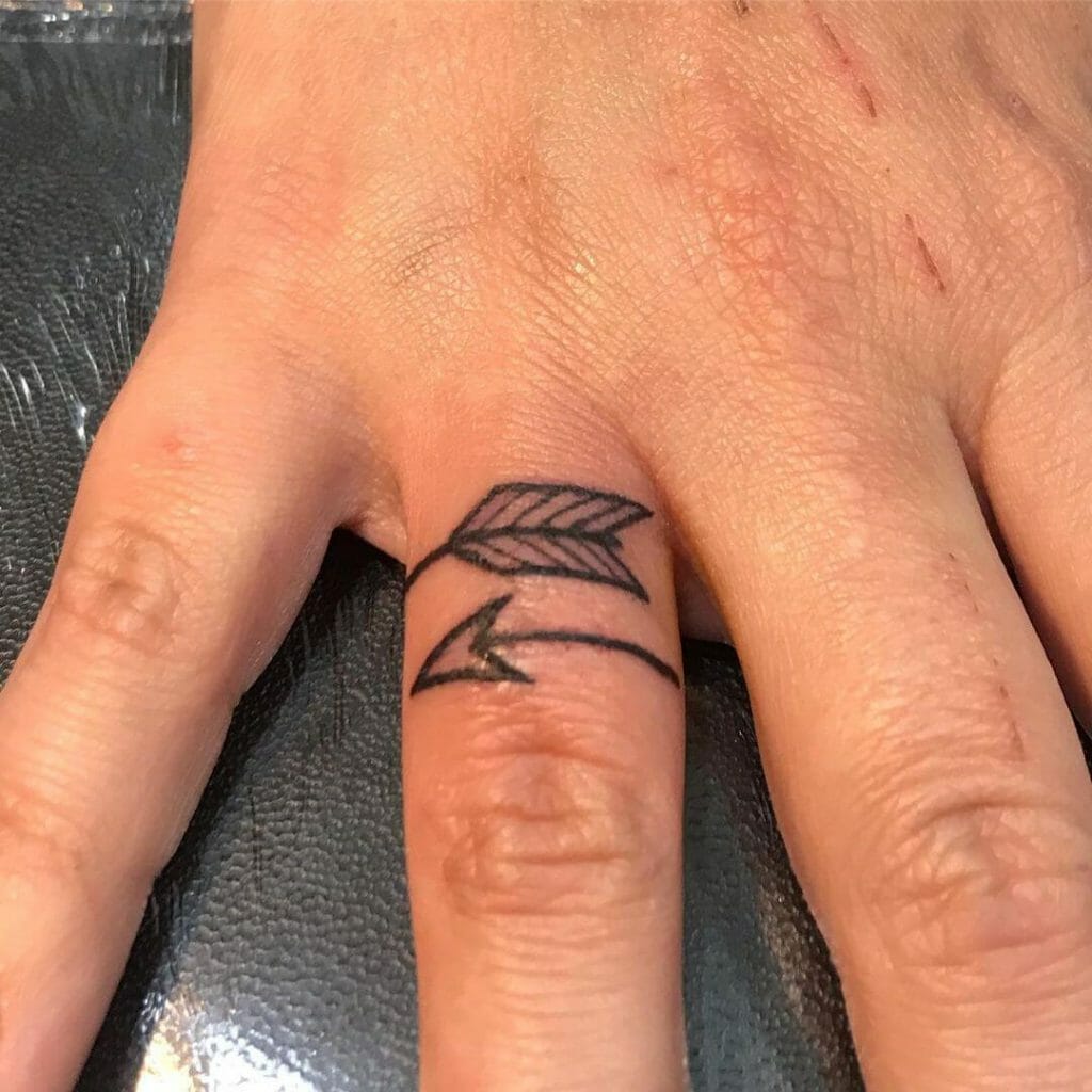 Wrap-Around Arrow Tattoo On Ring Finger