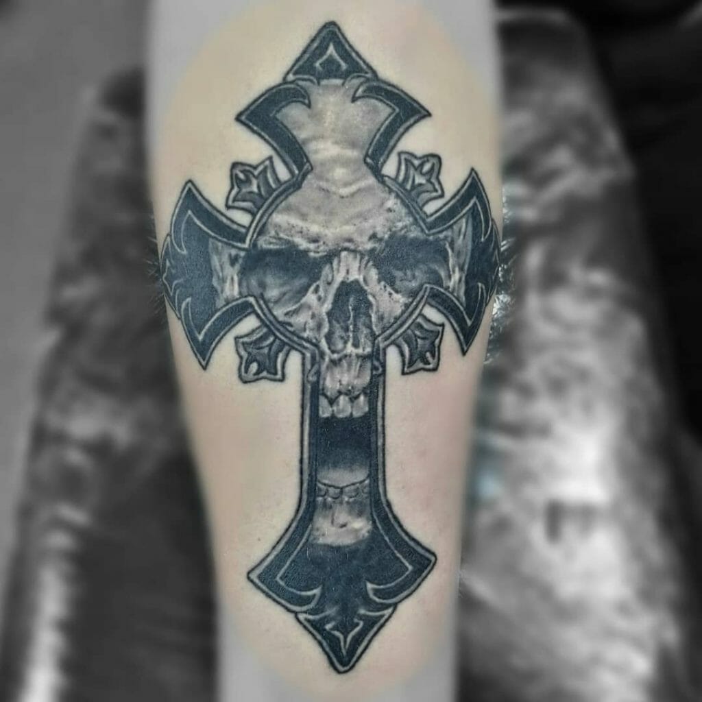 A Black And White Skull Tattoo With A Cross
