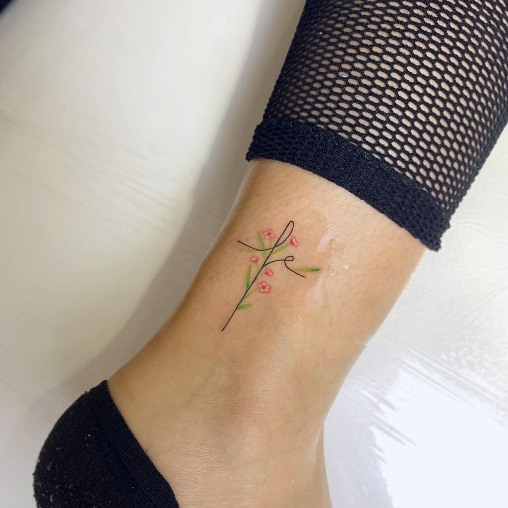 Delicate 'Fe' Cross Tattoo with Flowers