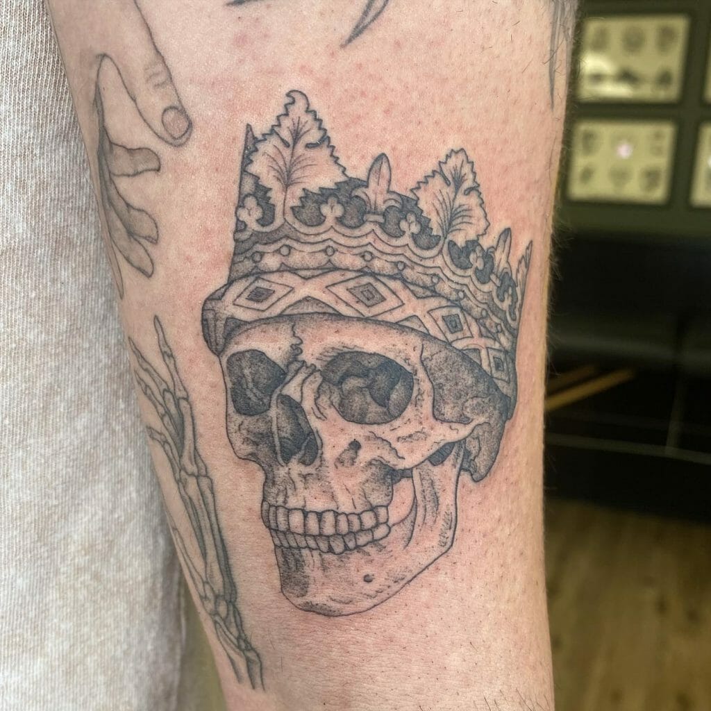 Minimalist Skull And Crown Tattoo