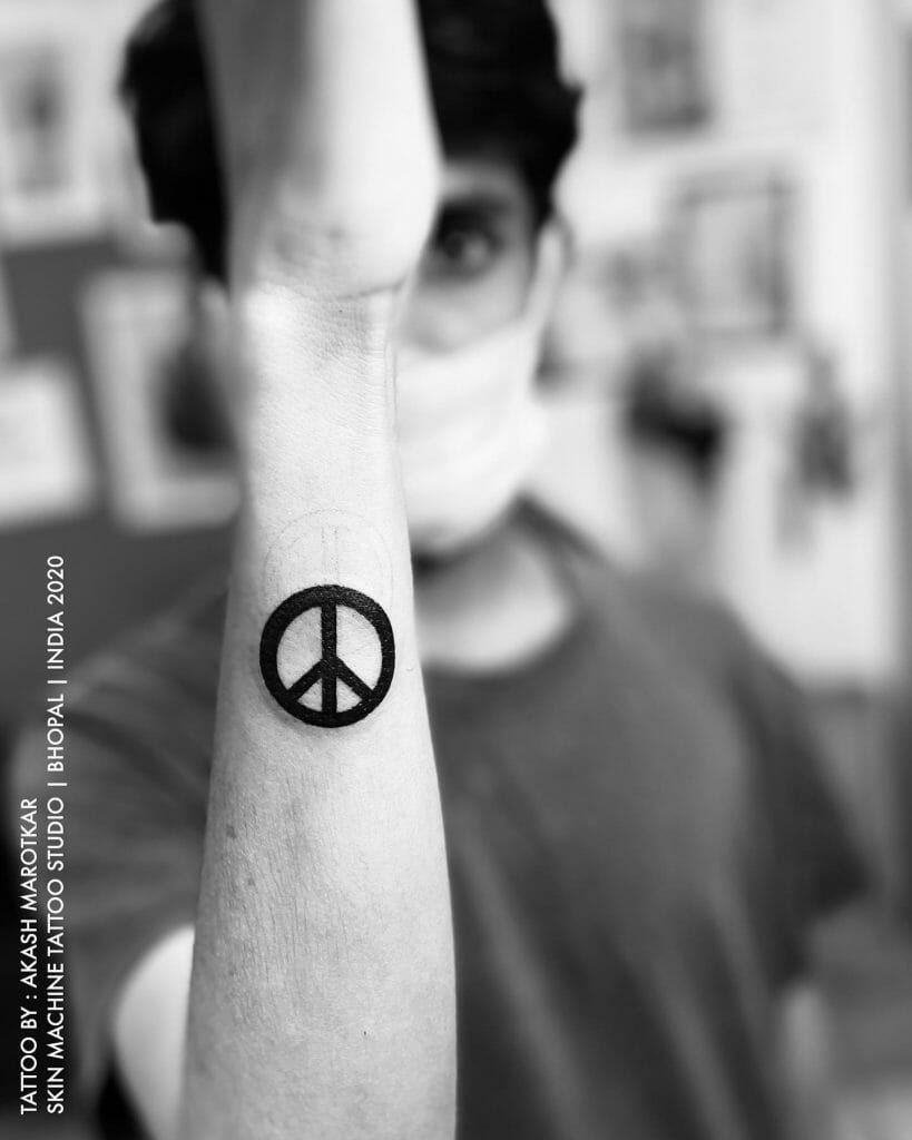 Simple Small Peace Tattoo On Arm