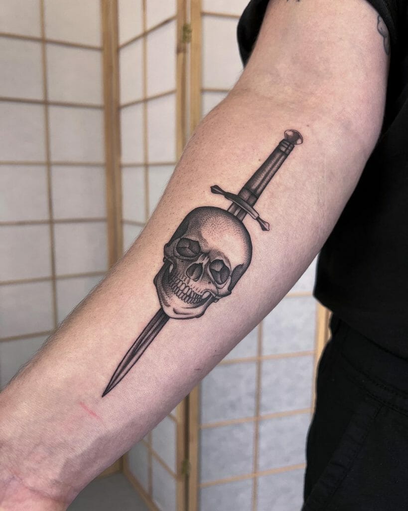 Small Black and White Skull and Blade Tattoo