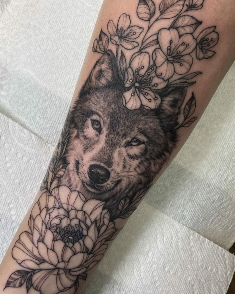 Smiling Wolf Amidst Flowers Forearm Tattoo