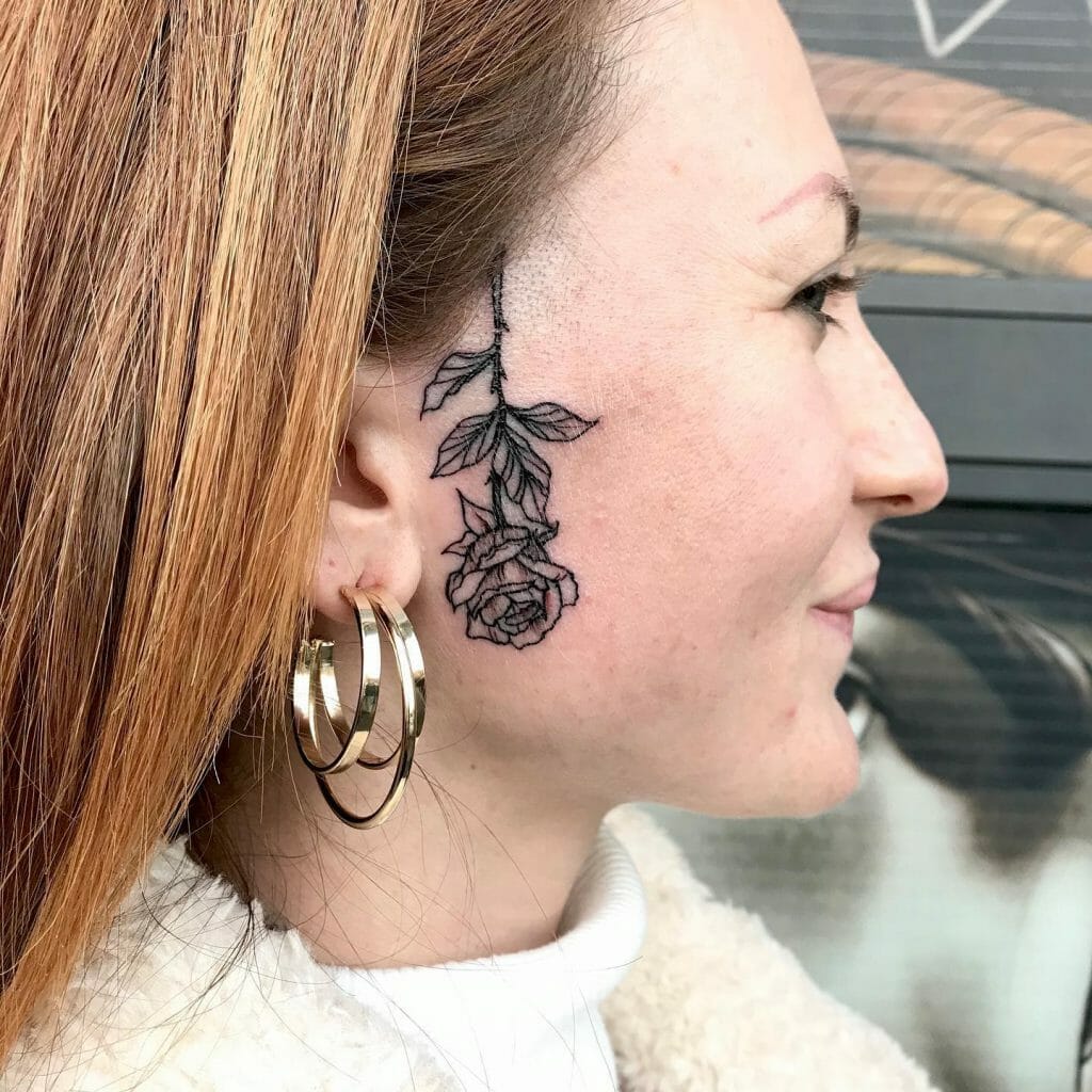 Upside Down Black Rose Tattoo On Face