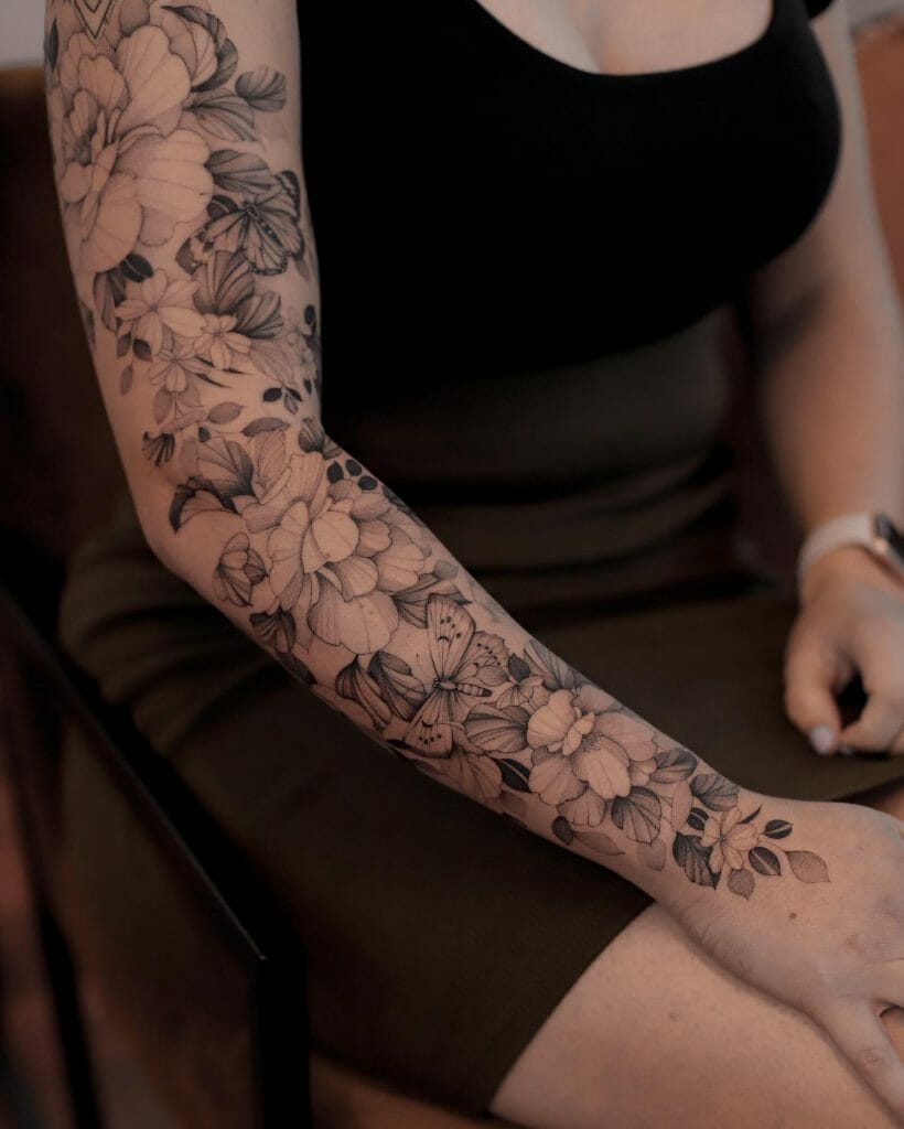A Beautiful Flower And Butterfly Sleeve Tattoo For Women
