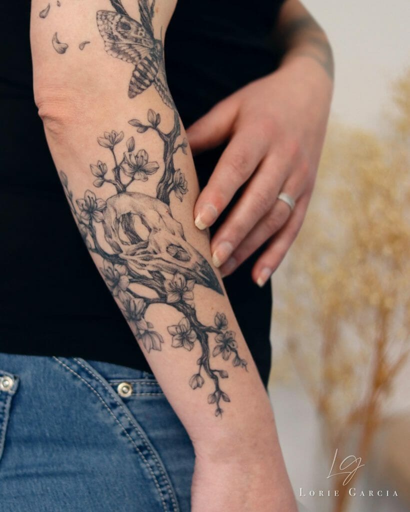 A Flower Blossoms And Raven Skull Sleeve Tattoo