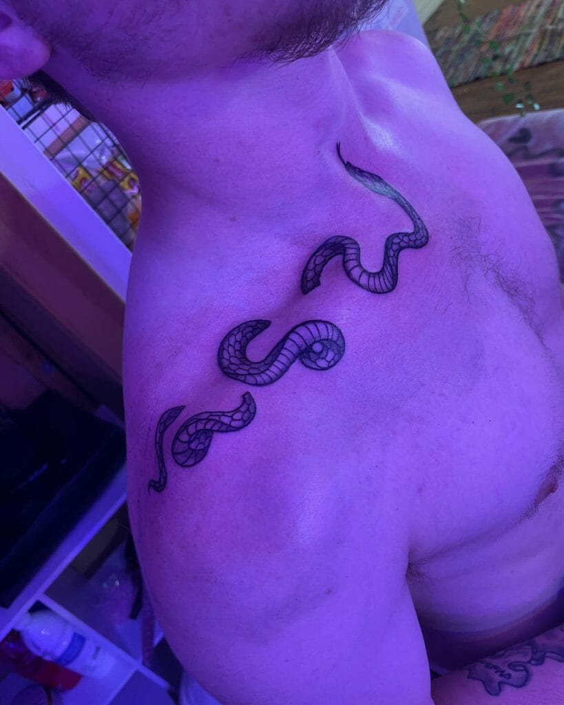 Beautiful trippy snake collarbone tattoo