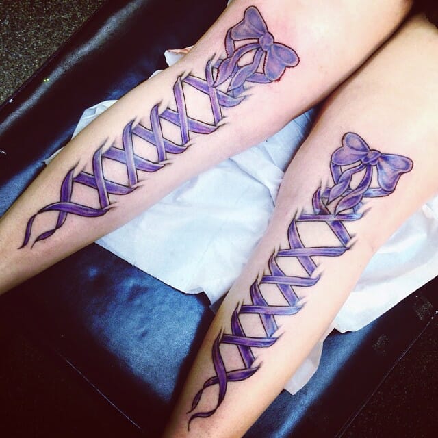 Corset Ribbon Tattoo On Side Of Thigh
