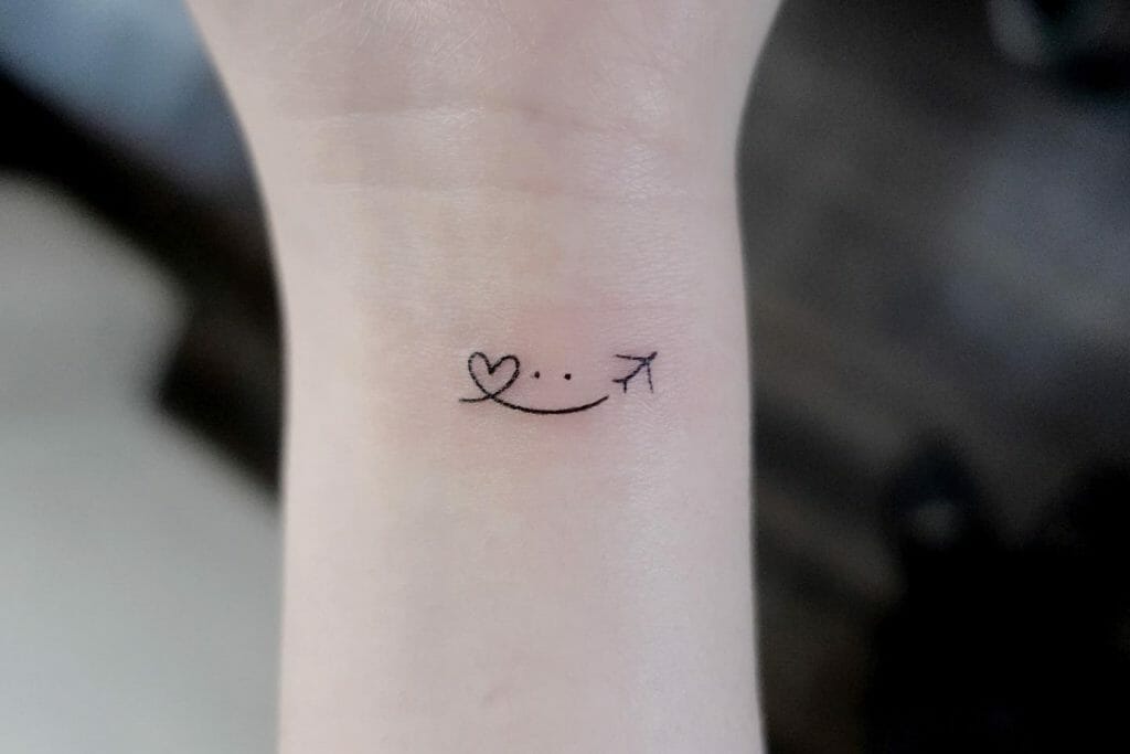 Heart Smile Plane Tattoo On Wrist