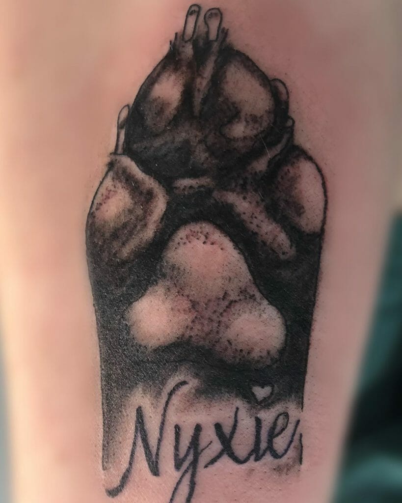 Heavily Detailed Dog Paw Print Tattoo With Name
