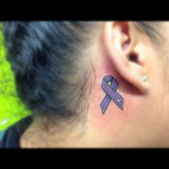 Tiny Behind the Ear Cancer Ribbon Tattoo