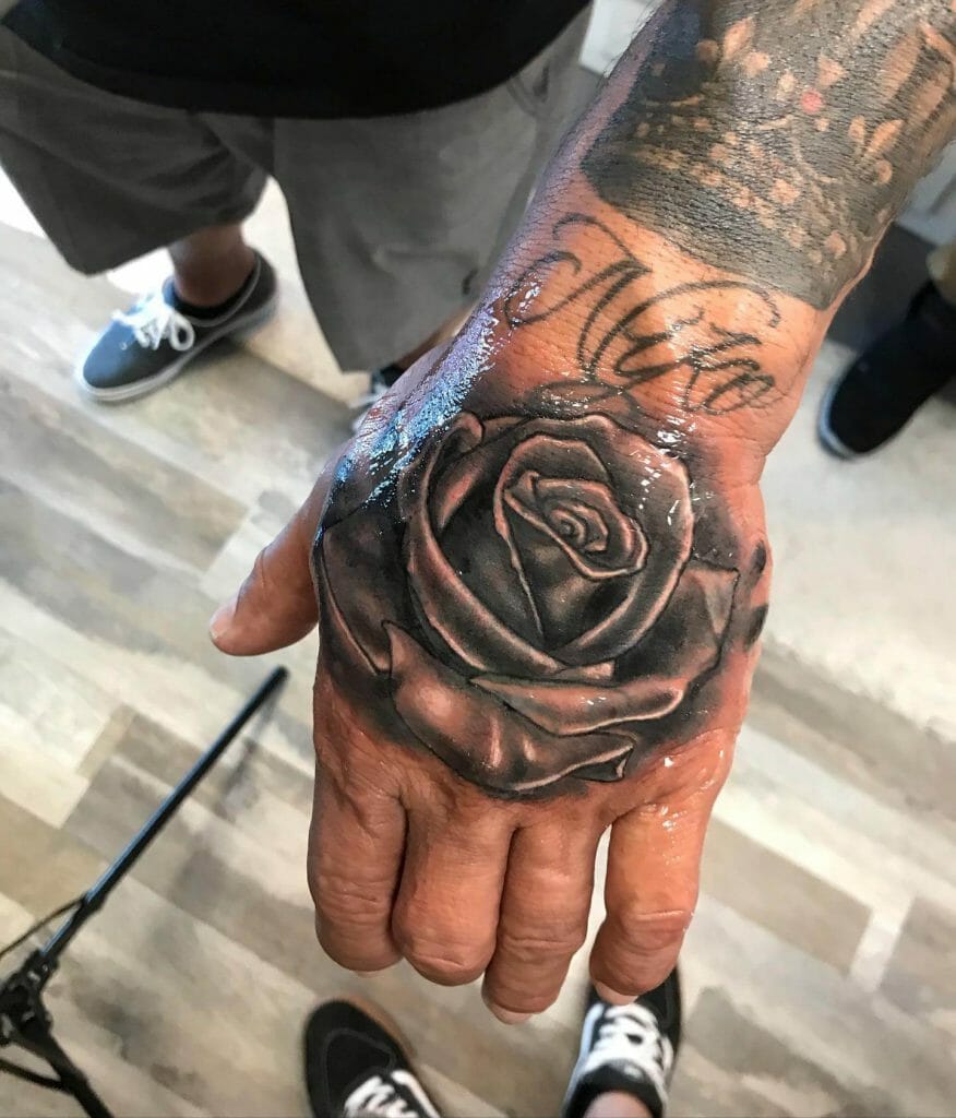  Dynamic Black And Grey Rose Hand Tattoo