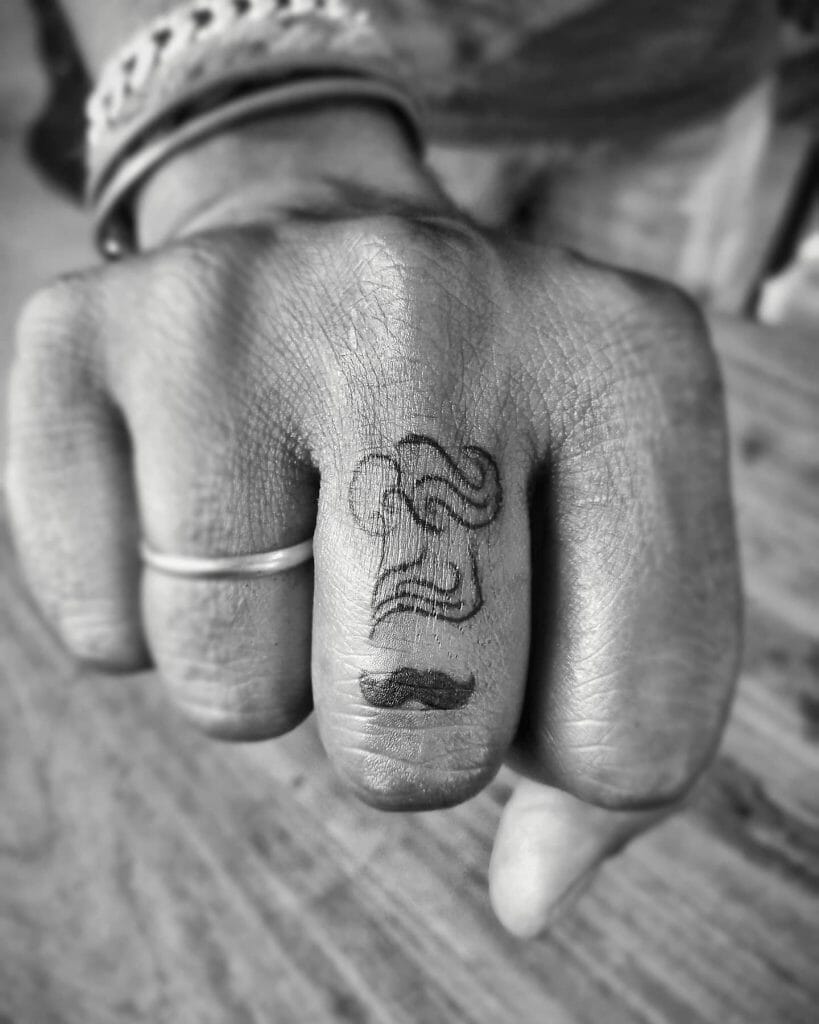  Dark Black Small Chef Tattoo On Finger