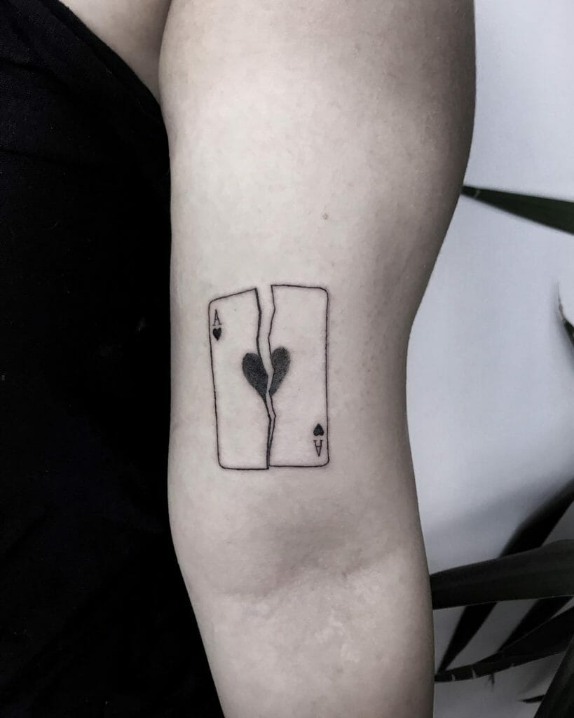A Tattoo Of Ace Of Hearts Split Into Two