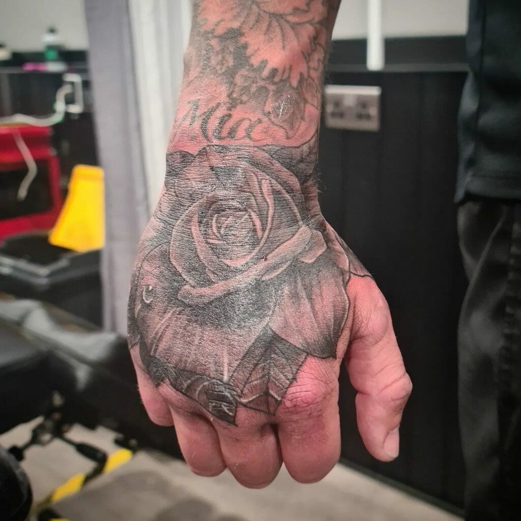  Beautiful Rose Hand Tattoo With Leaves