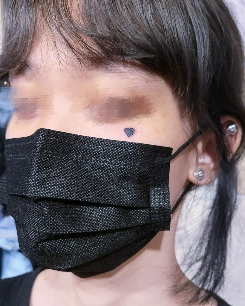 Under Eye Small Heart Tattoo On Face