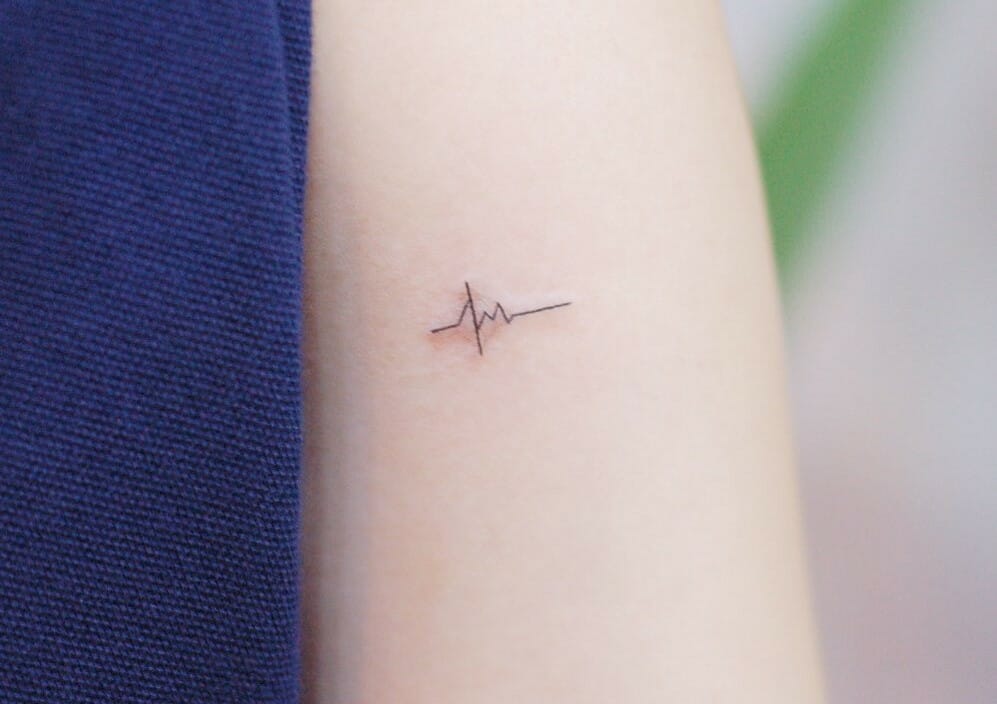 Tiny heartbeat tattoo done on the wrist.