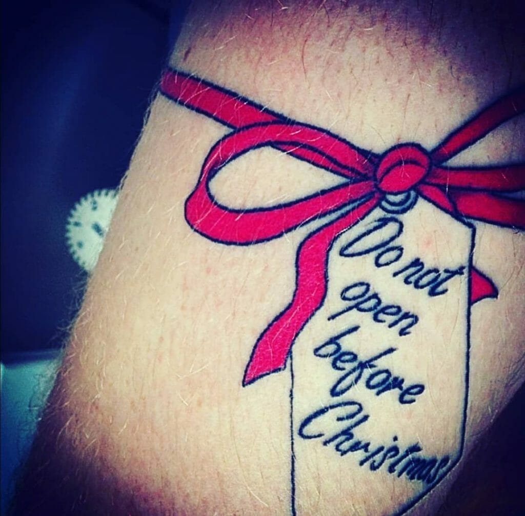 Do Not Open Before Christmas Bow Thigh Tattoo