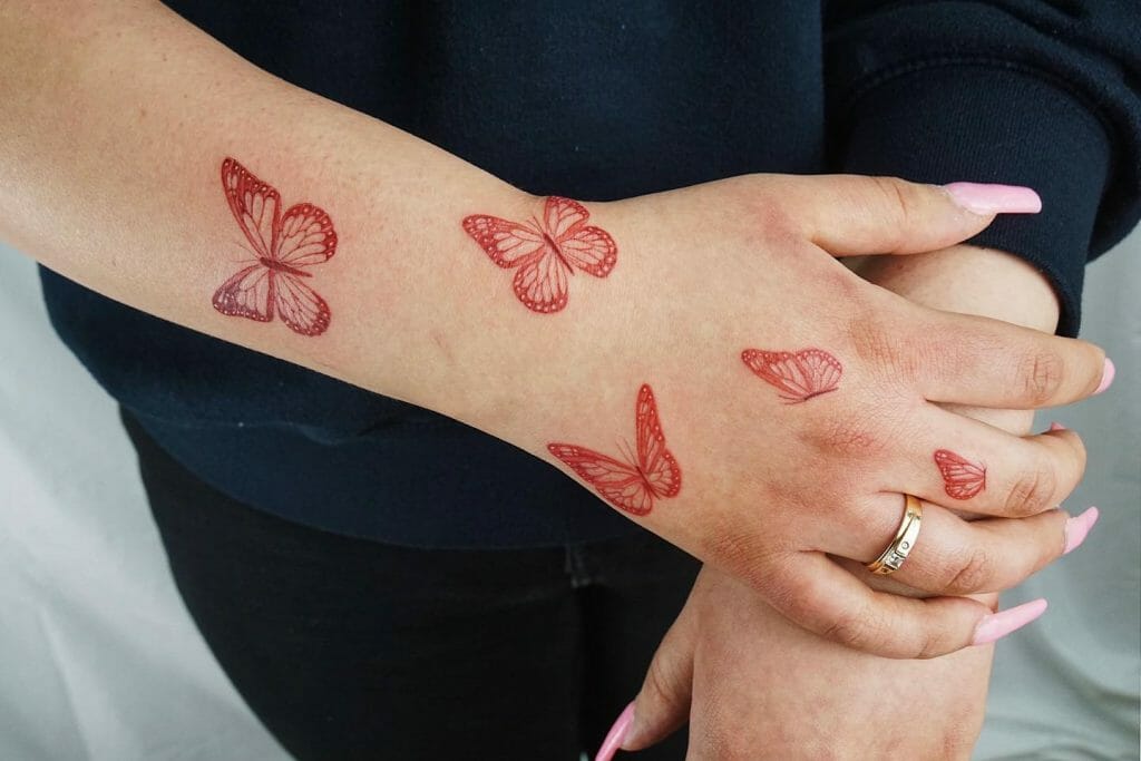Red Butterfly Finger Tattoo