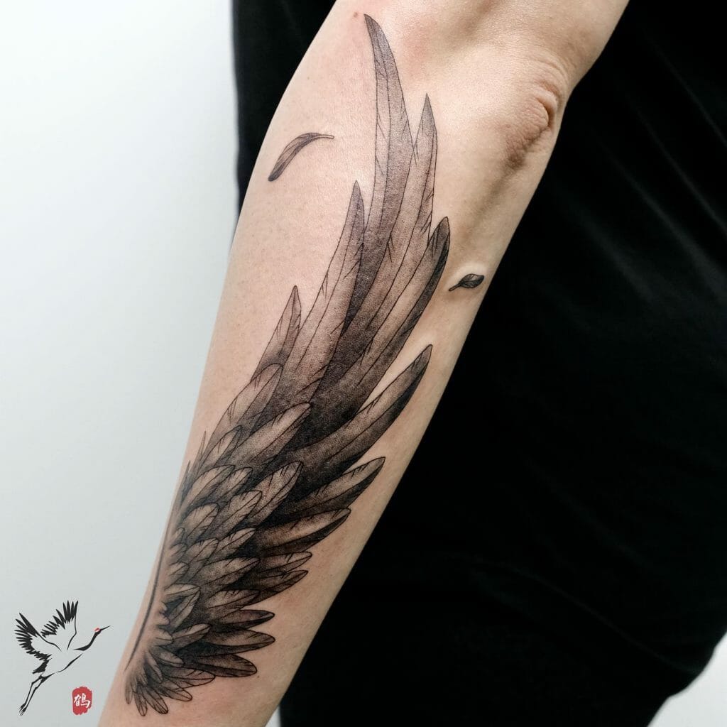 Wing & Floating Feathers Forearm Tattoo