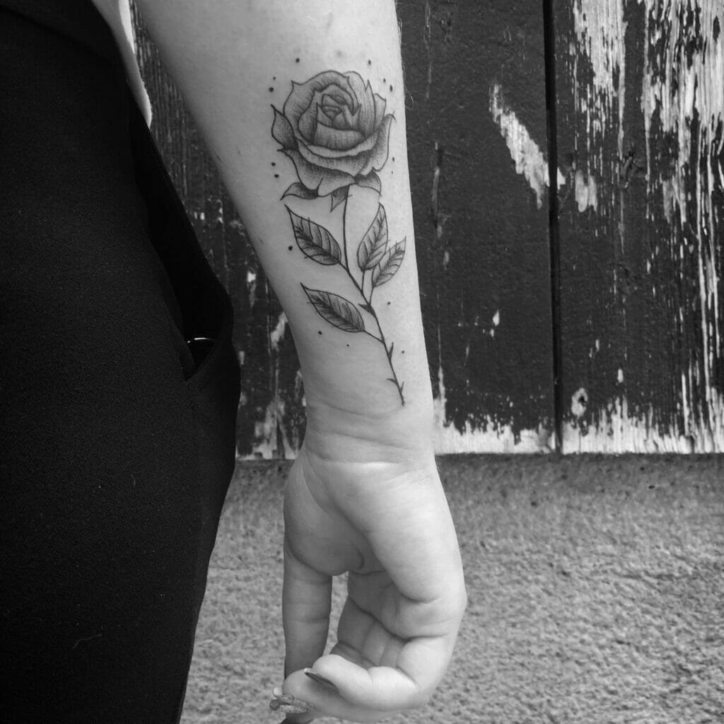 Black And Grey Inked Rose Sleeve Tattoo On Arm