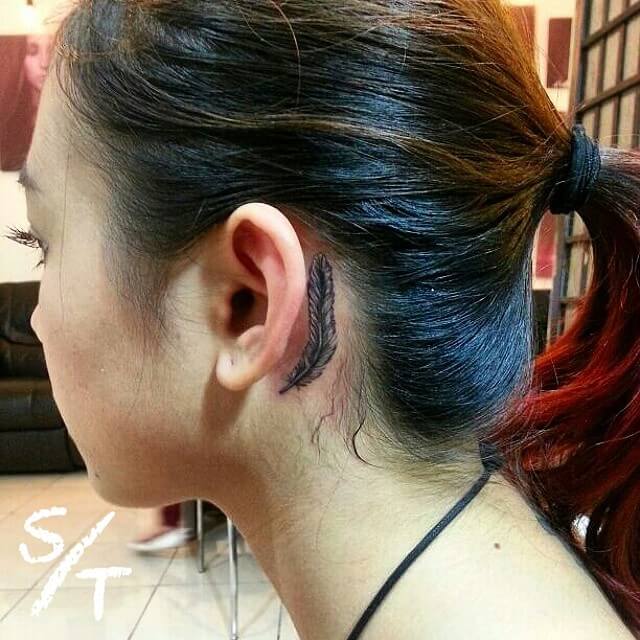 Female Behind The Ear Feather Tattoo