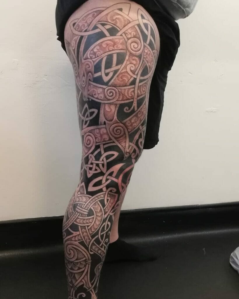 Red and black Celtic leg tattoo