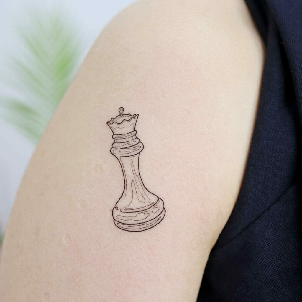 Right Biceps Tiny Queen Chess Piece Tattoo Design