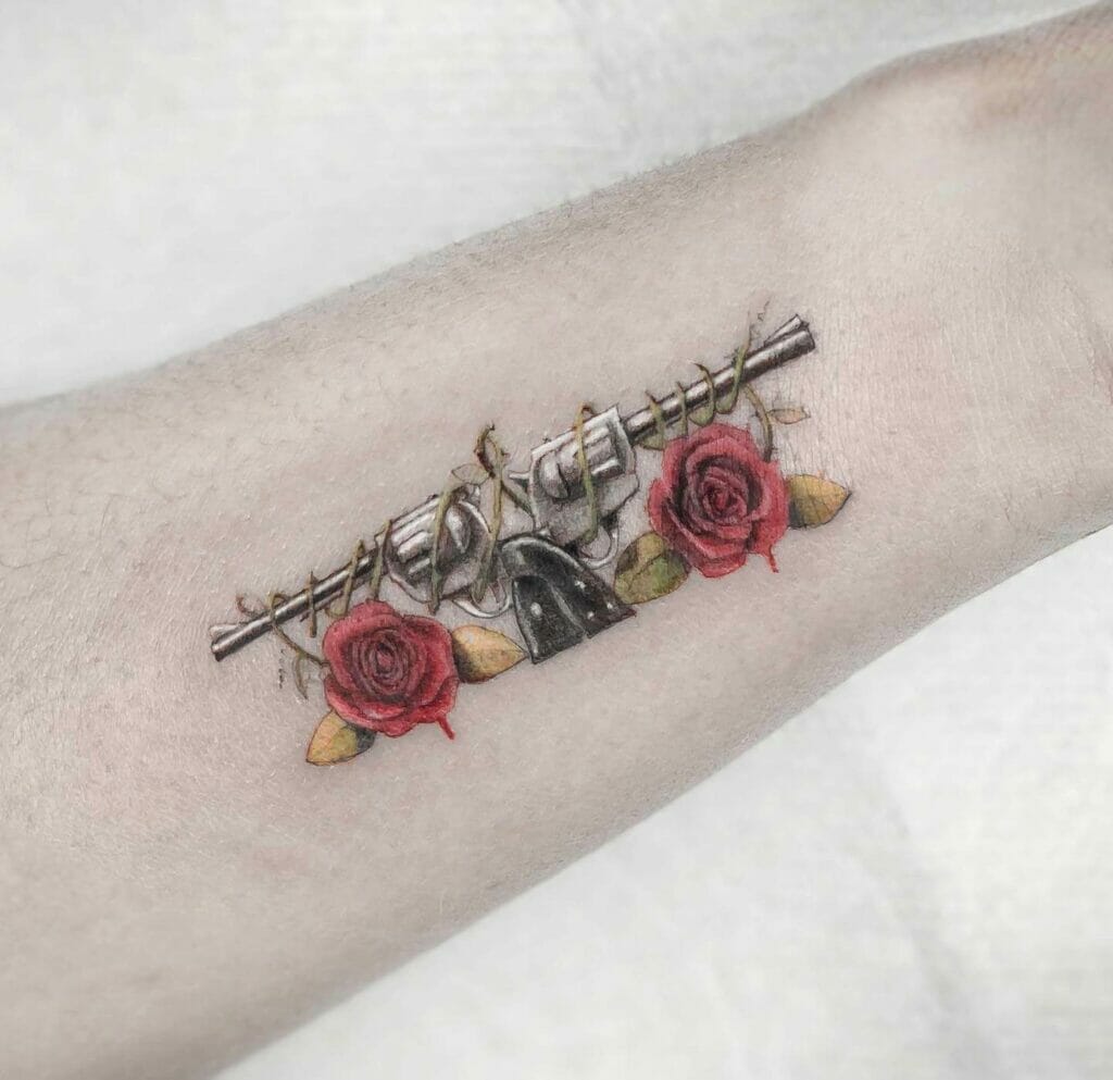 Simple Colored Gun And Roses Tattoo