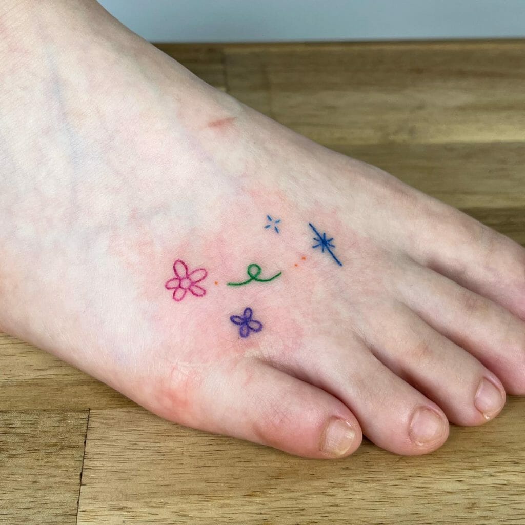 Flowers And Star Tattoo On Foot