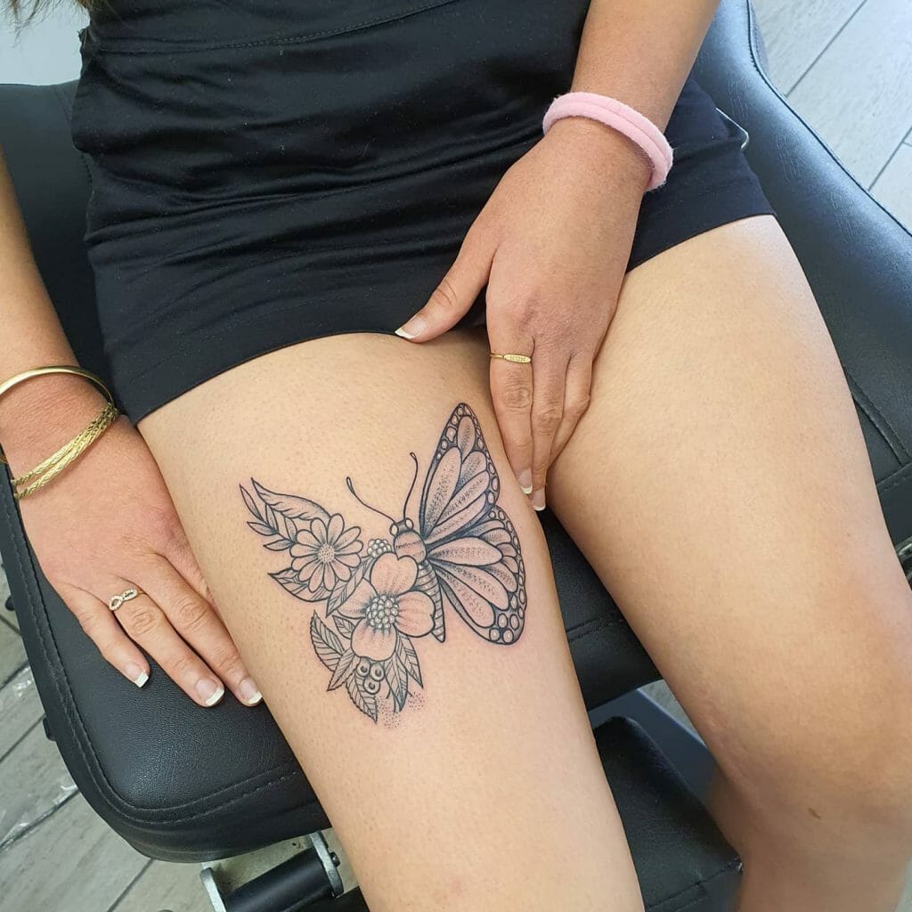 Half Butterfly On Flowers Tattoo