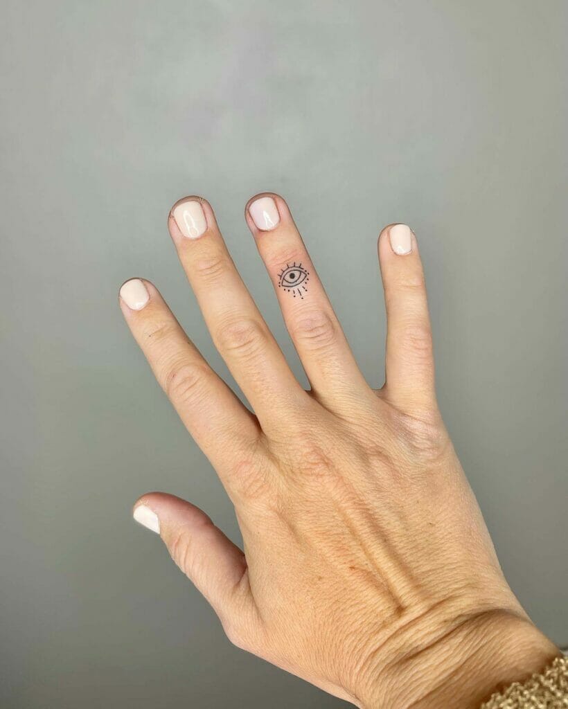 Finger Evil Eye Tattoo
