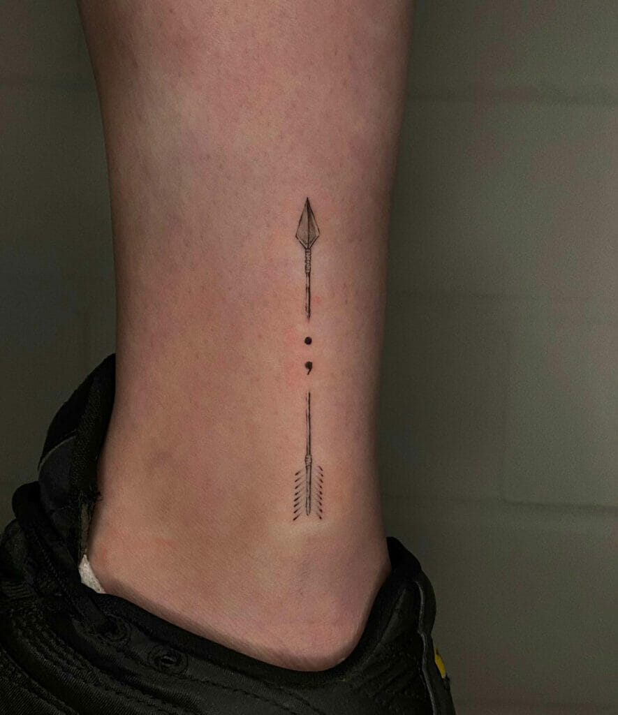 Female Arrow With Semicolon Tattoo