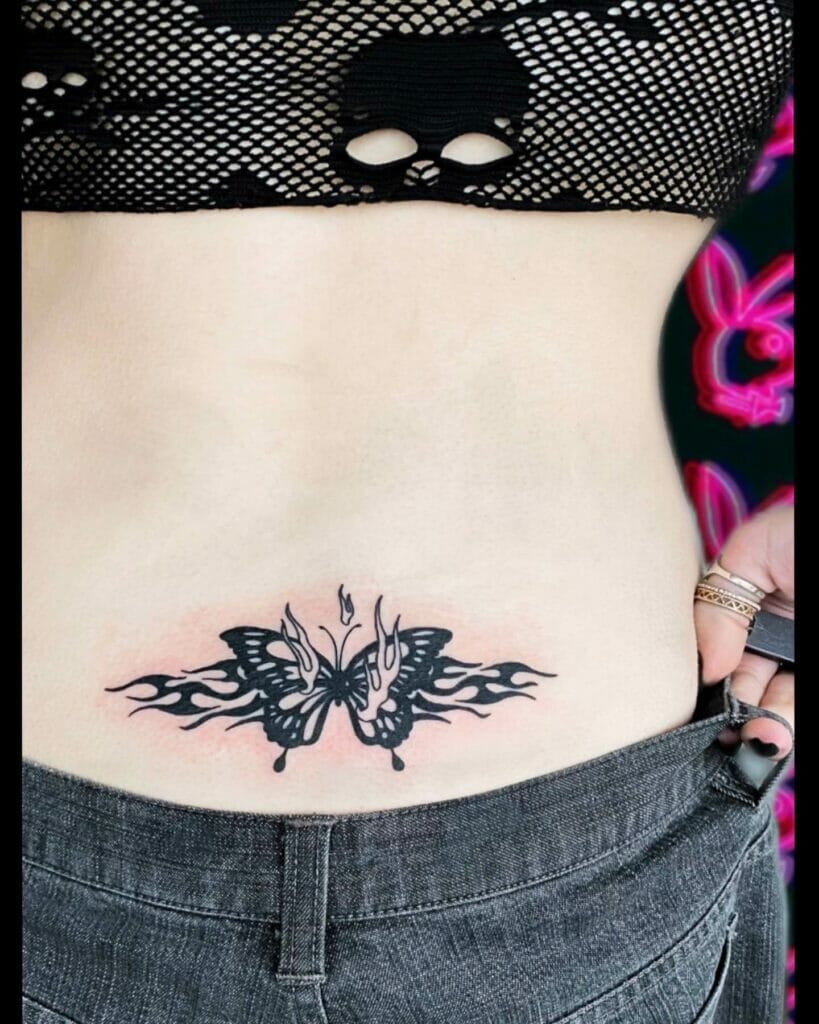 Punk Inspired Tiny Butterfly Tattoo On Lower Back