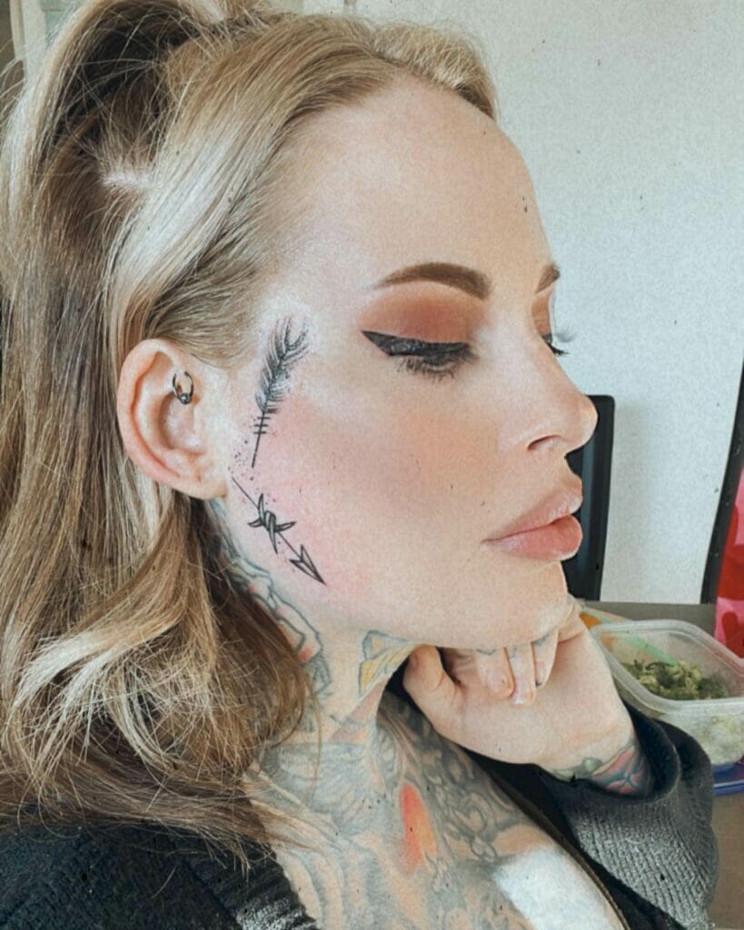Female Small Arrow Face Tattoo